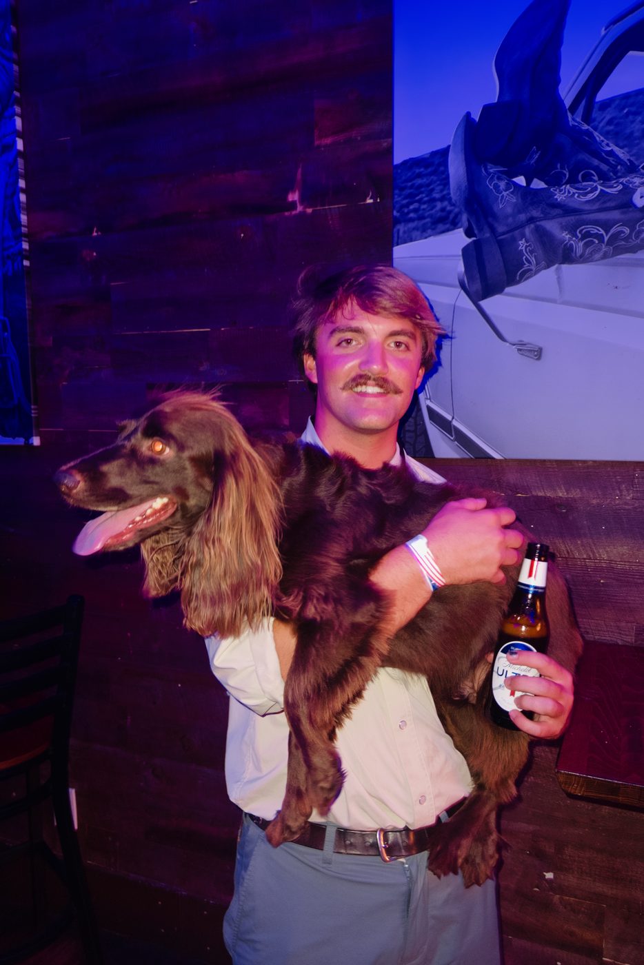 A guest with a dog at the Whiskey Ranch bar